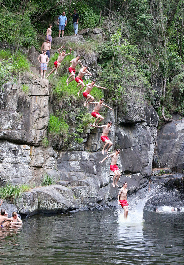 Jumping from rocks at Cedar Creek Falls