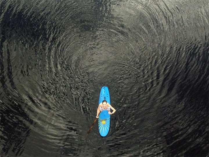 Bronwen trying to stand on a foam surfboard at Enoggera Reservoir