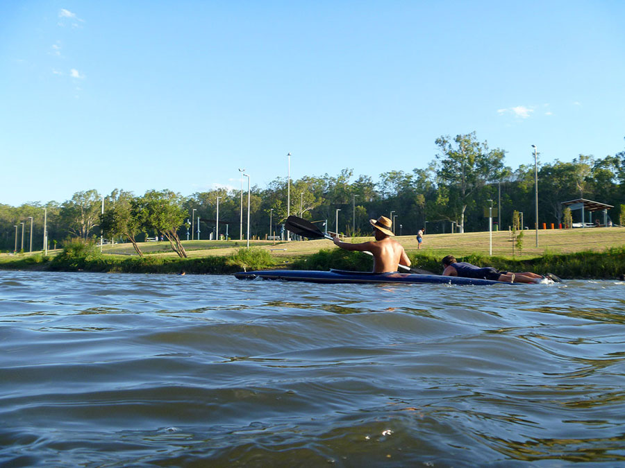Men paddle past, safe above the many aquatic creatures that can inflict bites and stings at College’s Crossing.
