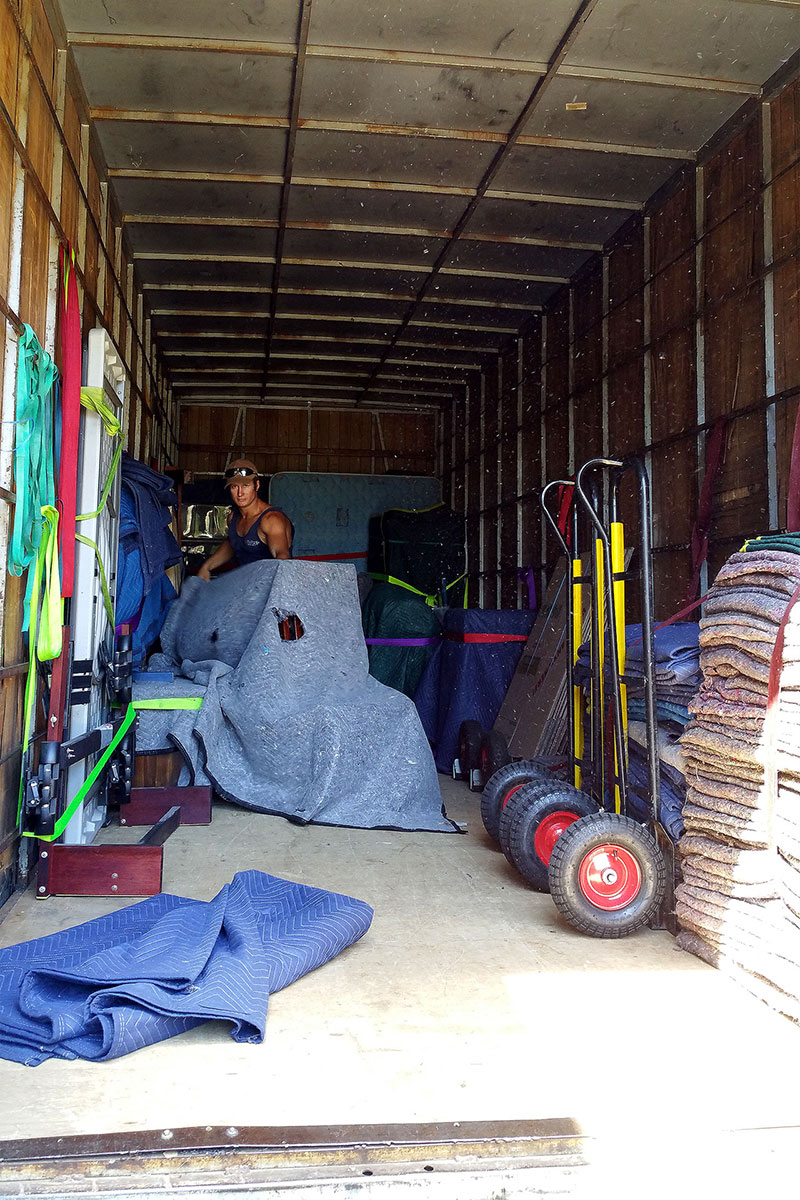 Removalists packing things into a truck