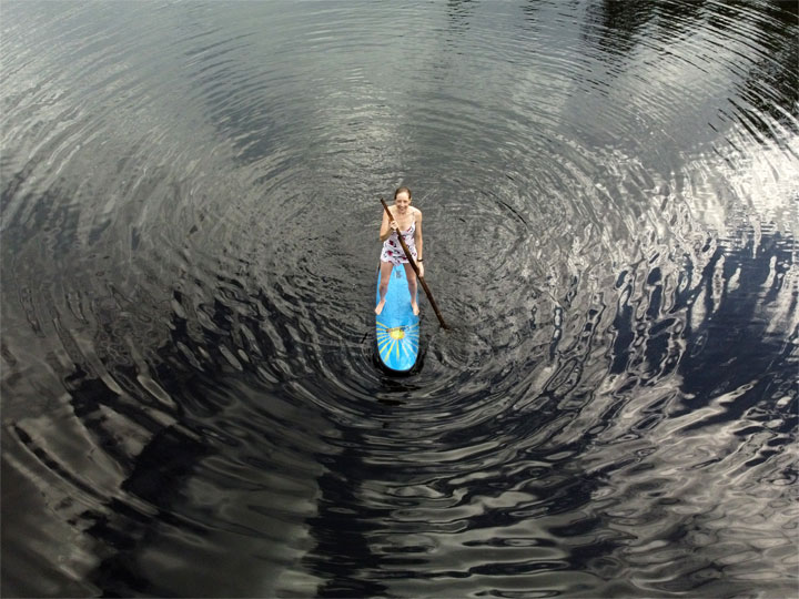 Bronwen trying to stand on a foam surfboard at Enoggera Reservoir