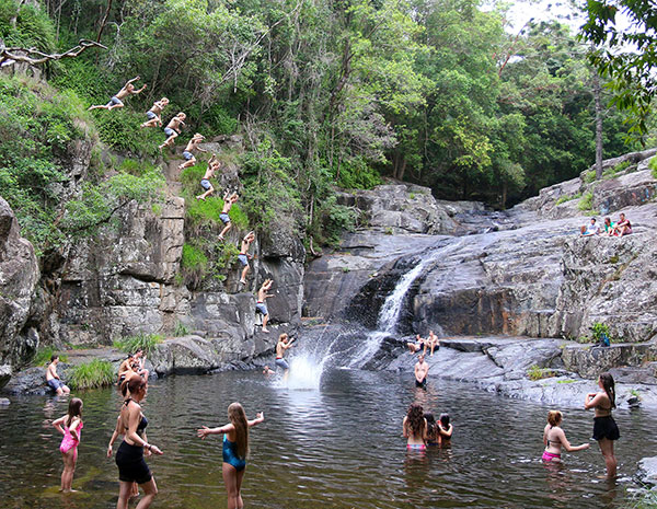 Jumping from rocks at Cedar Creek Falls