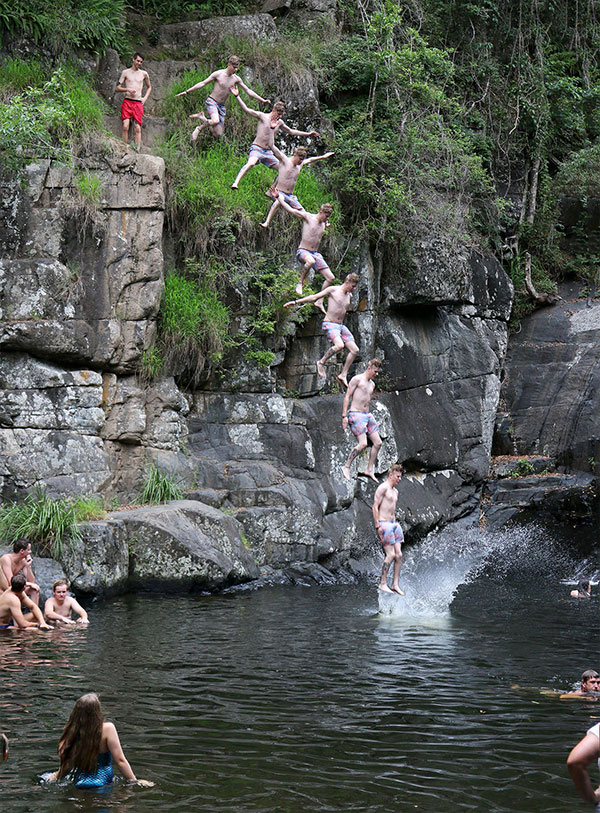 Jumping from rocks at Cedar Creek Falls