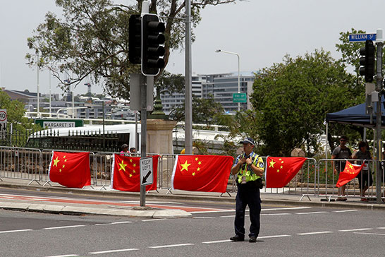 A protest, or a welcoming? Either way, very visible Chinese flags just across the road from the Falun Gong
