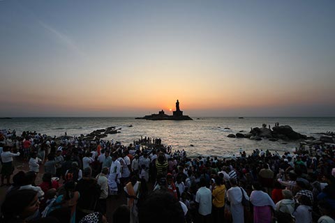 Crowds watch the sun rise at Cape Comorin