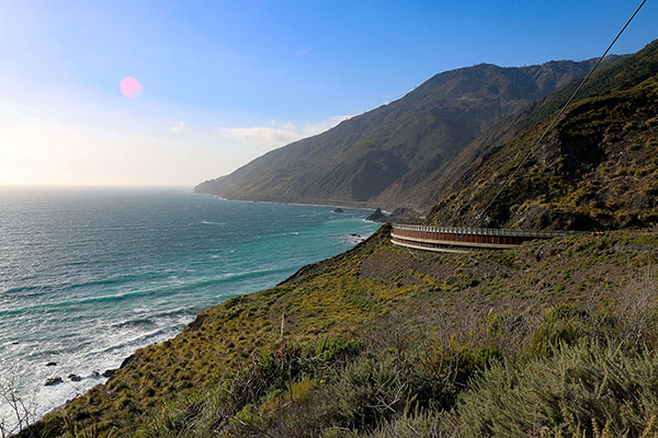 The road winds along the coastline