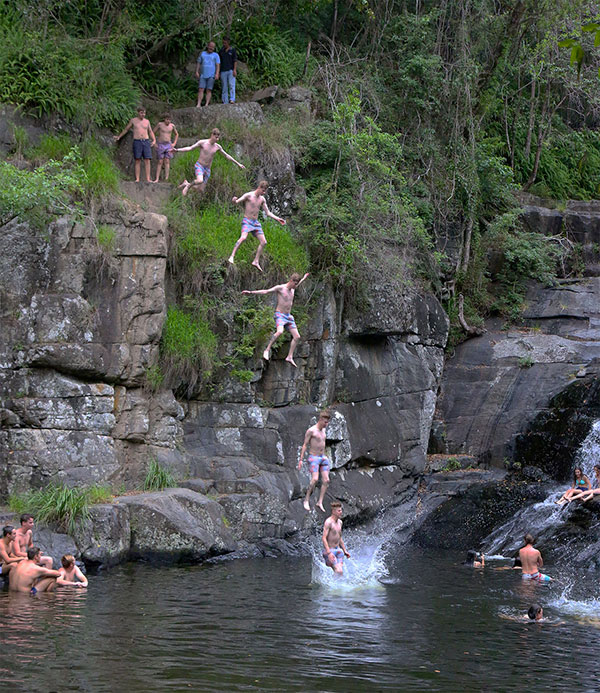 Jumping from rocks at Cedar Creek Falls