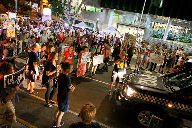 Protestors stop the police car from leaving