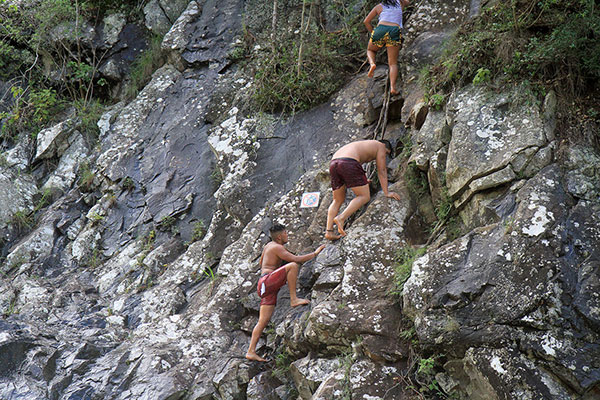 People ignore a no climbing sign, by climbing past it