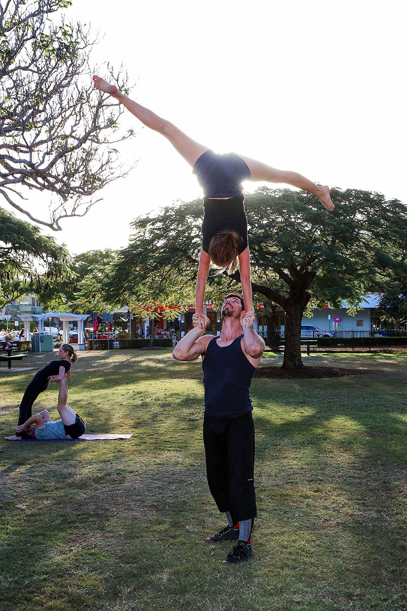 A woman balances on a man