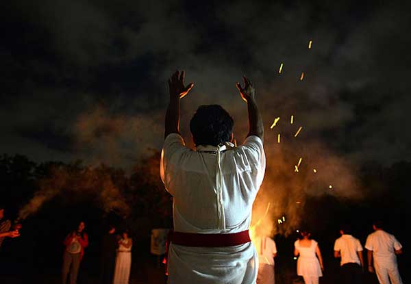 A Mayan priest performs a ritual during the ancient Chickaban feast to honor the feathered serpent Quetzalcoatl and the storm god Kukulcan, in the site were it was placed the circular temple, at the Xoclan Archaeo-ecological Park in Merida, Yucatan, Mexico, the night of Nov. 19, 2012. (Luis Perez/AFP/Getty Images)