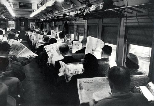 All this technology is making us antisocial: A tram full of people ignoring each other and reading the newspaper