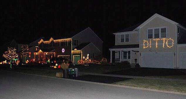 A house with Christmas lights reading “Ditto” and an arrow pointing at the house next door which is covered in Christmas lights.