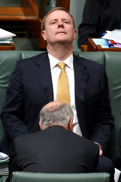 A photo of John Howard, former Australian Prime Minister, sitting in front of Peter Costello, former Australian Treasurer, in a way which suggests that Howard is performing fellatio on Costello.