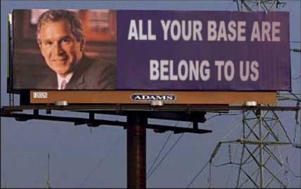 Billboard showing George Bush and reading "All Your Base Are Belong To Us"