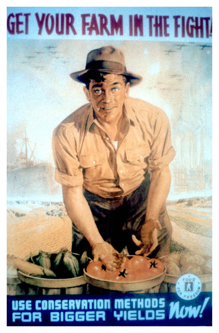 A farmer stands with baskets of produce