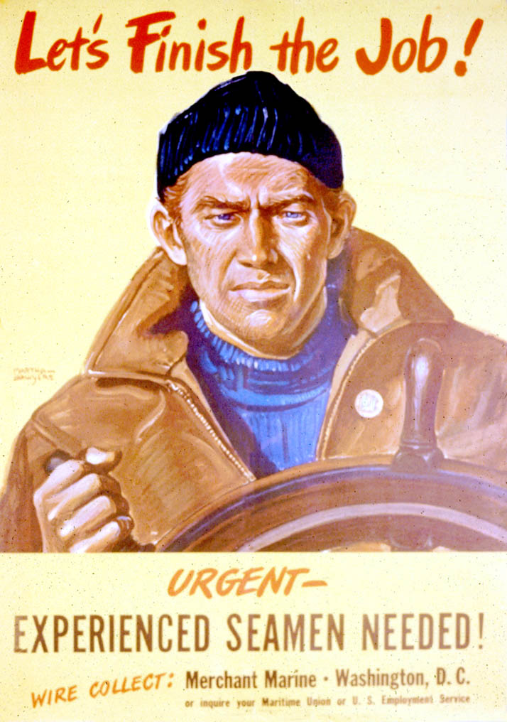 A sailor stands at the wheel