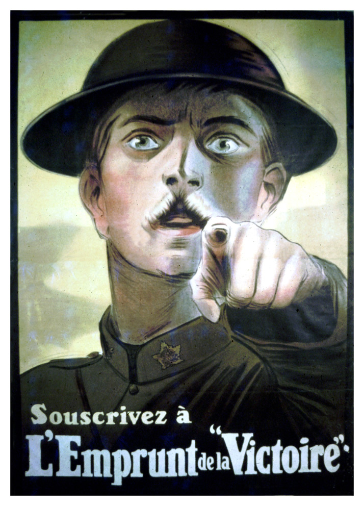 A wide eyed soldier pointing directly at the viewer