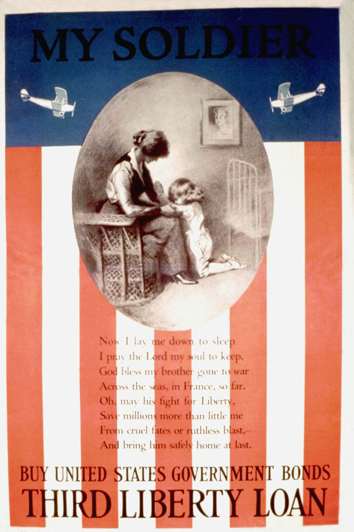Framed within the stripes and blue field of an American flag, a young girl is pictured praying with her mother