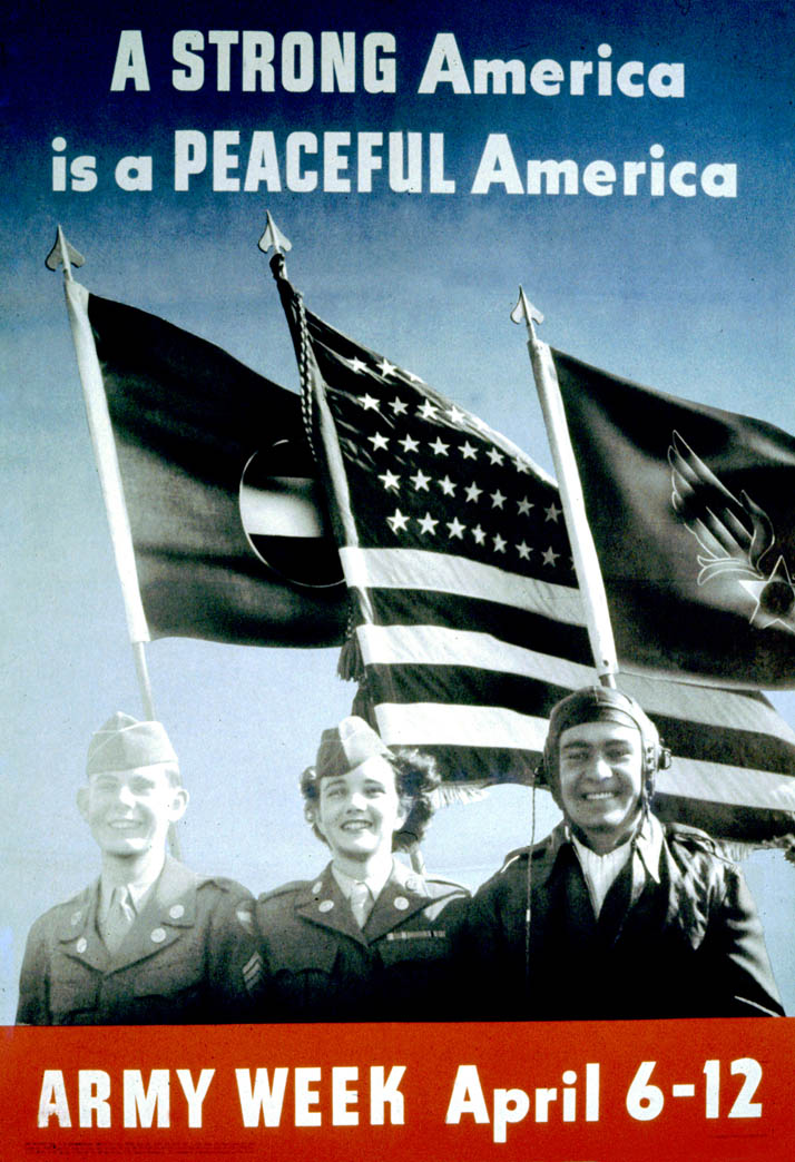 Two men and one woman, wearing uniforms, stand before three flags
